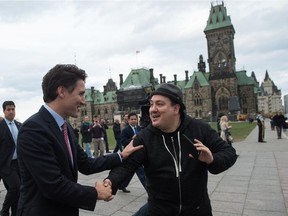 Justin Trudeau greets a well-wisher near the parliament buildings in Ottawa on Tuesday.