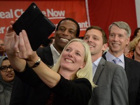 Newly elected Liberal MP's Catherine McKenna, left to right, Greg Fergus, Will Amos and Andrew Leslie pose for a selfie at a welcome rally for designate prime minister Justin Trudeau in a welcome rally in Ottawa on Tuesday, Oct. 20, 2015.