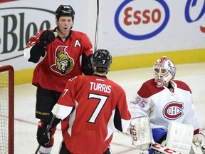Ottawa Senators' Chris Neil (25) celebrates his goal with Kyle Turris (7) against Montreal Canadiens goaltender Dustin Tokarski (35) during the first period of a preseason NHL hockey game on Saturday Oct. 3, 2015, in Ottawa.