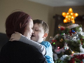 Seven-year-old Evan Leversage, who is battling cancer, at his home with his mother, Nicole Wellwood in St. George, Ont., on Oct. 21, 2015. Many people in the small town have been decorating early for Christmas in support of Evan, since doctors recommended the family may want to celebrate the holiday early.
