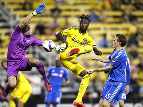 Columbus Crew forward Kei Kamara attempts to take shot as Impact goalkeeper Evan Bush (left) and defender Wandrille Lefevre try to stop him during MLS game in Columbus, Ohio, on June 6, 2015.