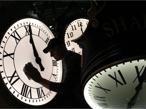 Dave LeMote wipes down a post clock at Electric Time Company, Inc. in Medfield, Mass., Friday, March 7, 2014.