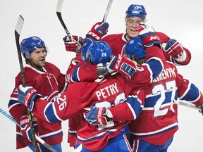 Montreal Canadiens' Jeff Petry (26) celebrates with teammates David Desharnais (51), Alex Galchenyuk (27) and Alexander Semin (13) after scoring against the Detroit Red Wings during third period NHL hockey action in Montreal, Saturday, Oct. 17, 2015.