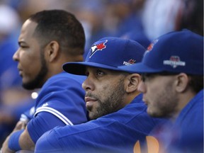 Toronto Blue Jays starting pitcher David Price, centre, watches the eighth inning of Game 2 of baseball's American League Championship Series against the Kansas City Royals, Saturday, Oct. 17, 2015, in Kansas City, Mo.