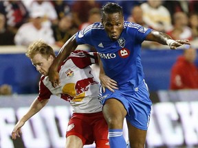 New York Red Bulls midfielder Dax McCarty, left, and Montreal Impact forward Didier Drogba compete for the ball during the second half of an MLS soccer match Wednesday, Oct. 7, 2015, in Harrison, N.J. The Red Bulls won 2-1.