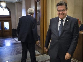 Montreal Mayor Denis Coderre right, smiles as the leader of the Bloq Quebecois, Gilles Duceppe leaves city hall after a meeting between the two, Monday, September 14, 2015