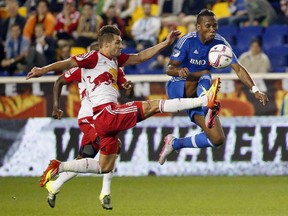 Montreal Impact forward Didier Drogba, right, and New York Red Bulls defender Damien Perrinelle compete for the ball during the first half of an MLS soccer match Wednesday, Oct. 7, 2015, in Harrison, N.J.
