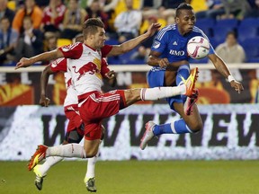 Montreal Impact forward Didier Drogba, right, and New York Red Bulls defender Damien Perrinelle compete for the ball during the first half of an MLS soccer match Wednesday, Oct. 7, 2015, in Harrison, N.J.