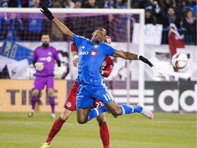 Montreal Impact forward Didier Drogba (11) and Toronto FC's Josh Williams battle for the ball during first half Major League Soccer sudden death playoff game Thursday, October 29, 2015 in Montreal.