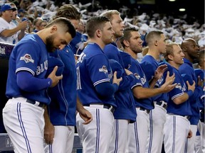 Toronto Blue Jays players stand during the anthems before game five of the American League Division Series against the Texas Rangers in Toronto earlier this month.