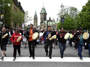 Drummers pass Parliament Hill as they lead the Walk for Reconciliation, part of the closing events of the Truth and Reconciliation Commission on May 31, 2015, in Ottawa.