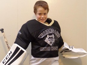 Eight-year-old Amdeus Isnardy tries out goalie gear donated by  Carey Price to his old junior hockey association.