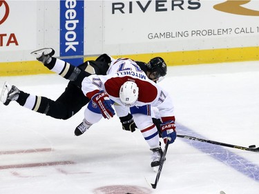Montreal Canadiens' Torrey Mitchell (17) collides with Pittsburgh Penguins' Evgeni Malkin (71) during the first period of an NHL hockey game in Pittsburgh Tuesday, Oct. 13, 2015.