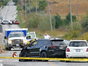 Police investigate the scene after a fatal accident in Vaughan, Ont., north of Toronto, on Sunday, Sept.27, 2015. A 29-year-old man faces 18 impaired-driving charges after three young children and their grandfather died following a three-car crash north of Toronto.