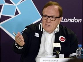 In this July 27, 2012, file photo, Canadian Olympic Committee president Marcel Aubut speaks to reporters during a news conference for the 2012 Summer Olympics in London. Aubut has resigned as president of the Canadian Olympic Committee while under investigation for a sexual-harassment complaint. The committee said in a statement Saturday, Oct. 3, 2015, its investigation now ends. Since the original complaint, two other women made allegations against Aubut.