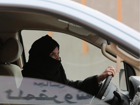 Aziza Yousef drives a car on a highway in Riyadh, Saudi Arabia, as part of a campaign last year to defy Saudi Arabia's ban on women driving.