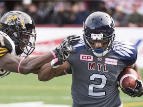 Alouettes' Fred Stamps is tackled by Hamilton Tiger-Cats' Jalil Carter during second half CFL football action in Montreal, Sunday, October 18, 2015.