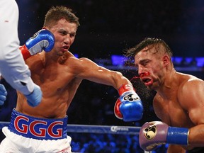 Gennady Golovkin, left, hits David Lemieux of Laval in the eighth round of a world middleweight title fight at Madison Square Garden in New York on Saturday, Oct. 17, 2015. Golovkin won by a TKO in the eighth round.