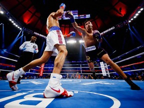 Gennady Golovkin exchanges punches with David Lemieux during their WBA/WBC interim/IBF middleweight title unification bout at Madison Square Garden on Oct. 17, 2015, in New York City.