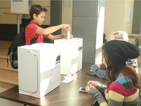 Grade 9 student Jordan Smith puts his ballot in the ballot box during the student vote for the federal election at Charles Spencer High school on Knowledge Way on Wednesday October 14, 2015 in Grande Prairie, Alta. Organized by CIVIX, the Student Vote program allows students under the age of majority to participate in mock federal, provincial and municipal elections to learn about the electoral process.