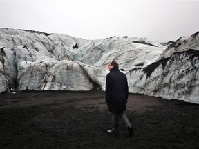 France's President François Hollande walks on the Solheimajokull glacier in Iceland, where the ice has retreated by more than one kilometre, during a visit in Iceland on October 16, 2015. François Hollande is in Iceland to experience damage thought to be caused by global warming, ahead of major UN talks on climate change in Paris this year.