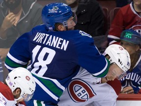 Canucks' Jake Virtanen checks Canadiens' Lars Eller during the third period in Vancouver on Tuesday, Oct. 27, 2015.