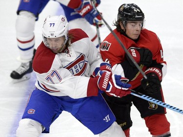Ottawa Senators' Jean-Gabriel Pageau (44) clashes with Montreal Canadiens' Tom Gilbert (77) during the second period of a pre-season NHL hockey game, Saturday, October 3, 2015, in Ottawa.