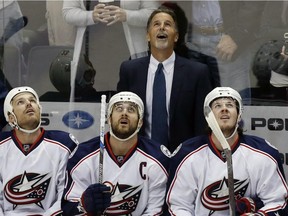 Columbus Blue Jackets new head coach John Tortorella joins his players watching a replay on a goal by Minnesota Wild's Zach Parise against Blue Jackets goalie Sergei Bobrovsky during the first period on Thursday, Oct. 22, 2015, in St. Paul, Minn.