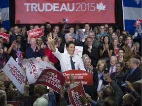 Liberal leader Justin Trudeau salutes supporters during a rally Tuesday, October 6, 2015 in Sherbrooke, Quebec.