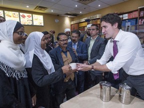 Liberal leader Justin Trudeau serves chai during a campaign stop at a restaurant Friday, October 16, 2015 in Brampton, Ont.