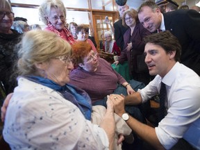 Liberal leader Justin Trudeau chats with supporters during a campaign stop at a coffee shop on Oct. 6, 2015, in Granby.