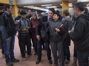 Prime minister-designate Justin Trudeau greets and takes photos with constituents at a subway station in his riding Tuesday, October 20, 2015 in Montreal, the morning after winning a majority government in the federal election.