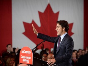 Liberal leader Justin Trudeau waves to the crowd after his speech at Liberal election headquarters in Montreal, Que. on Monday, October 20, 2015.