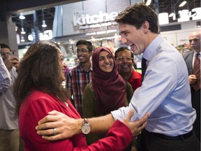 Liberal leader Justin Trudeau greets supporters during a campaign event at a grocery store Friday in Toronto.