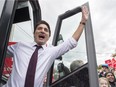 Liberal Leader Justin Trudeau waves from his bus as he arrives for a campaign event Wednesday, October 14, 2015 in St. Catharines, Ont.