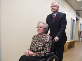 Former Quebec lieutenant governor Lise Thibault is pushed by aide Real Cloutier, Wednesday, September 30, 2015 at the courthouse in Quebec City.