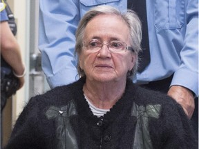 Former Lt. Governor Lise Thibault is escorted by special constables as she leaves the courtroom, handcuffed, after she appealed her sentence, Tuesday, Oct.r 6, 2015 in Quebec City.