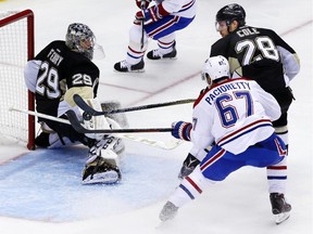 Canadiens' Max Pacioretty can't get his stick on a rebound behind Penguins goalie Marc-Andre Fleury, with Ian Cole defending during the third period in Pittsburgh on Tuesday, Oct. 13, 2015.