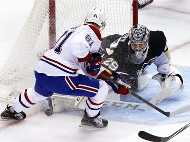 Pittsburgh Penguins goalie Marc-André Fleury stops a shot by Montreal Canadiens' Lars Eller (81) during the first period of an NHL hockey game in Pittsburgh Tuesday, Oct. 13, 2015.