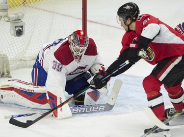 Ottawa Senators right wing Mark Stone tries to put the puck past Montreal Canadiens goalie Mike Condon during first period NHL action Sunday, October 11, 2015, in Ottawa.