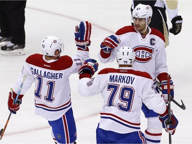 Montreal Canadiens' Max Pacioretty (67) celebrates his goal with teammates Brendan Gallagher (11), and Andrei Markov (79) in the first period of an NHL hockey game against the Pittsburgh Penguins in Pittsburgh Tuesday, Oct. 13, 2015.