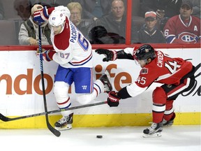 Montreal Canadiens captain Max Pacioretty (67) keeps the puck away from Ottawa Senators' Chris Wideman (45) during the third period of a pre-season NHL hockey game, Saturday October 3, 2015, in Ottawa. The Senators won 5-4.