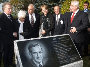 Members of the family of slain Quebec MP, Pierre Laporte, gather with Quebec Premier, Jean Charest and Francoise Brouillet (Laporte's wife next to Charest) and son Jean (third from left)), in St Lambert, on the south shore of Montreal, Sunday, October 17, 2010, for the unveiling of a plaque commemorating the 40th anniversary of the his murder in October, 1970  during the October Crisis. Quebec MP Nicole Menard (centre) and Phillipe Brunet (far right) the mayor of St Lambert were also in attendance.