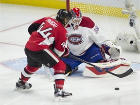 Ottawa Senators' Jean-Gabriel Pageau tries to put the puck past Montreal Canadiens goalie Mike Condon during second period NHL action Sunday, Oct. 11, 2015, in Ottawa.