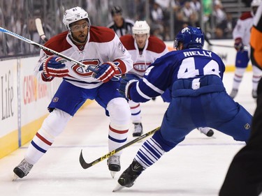 Montreal Canadiens' Devante Smith-Pelly(21) skates down the wing as Toronto Maple Leafs' Morgan Rielly (44) defends during first period NHL action in Toronto on Wednesday, Oct. 7, 2015.