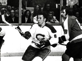 Montreal Canadiens forward Jim Roberts (left), photographed in a  mid-1970s Forum game against the Philadelphia Flyers. At right is the  Flyers' Dave (The Hammer) Schultz.