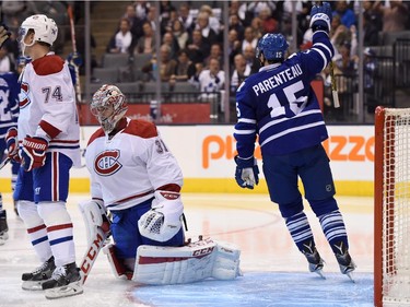 Montreal Canadiens goalie Carey Price reacts as Toronto Maple Leafs' Pierre-Alexandre Parenteau (15) celebrates a goal by teammate James van Riemsdyk during second period NHL action in Toronto on Wednesday, Oct. 7, 2015.