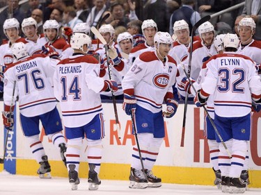 Canadiens players celebrate defeating the Maple Leafs in NHL action in Toronto on Oct. 7, 2015. The Canadiens defeated the Maple Leafs 3-1.