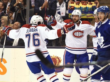 Montreal Canadiens teammates P.K. Subban (76) Andrei Markov (79) and Max Pacioretty (67) celebrate Pacioretty's goal against the Toronto Maple Leafs' during first period NHL action in Toronto on Wednesday, Oct. 7, 2015.