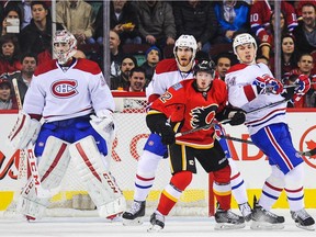 Flames' Paul Byron battles for position in front of new Canadiens teammates Carey Price, Jarred Tinordi and Alexei Emelin in 2014 in Calgary.